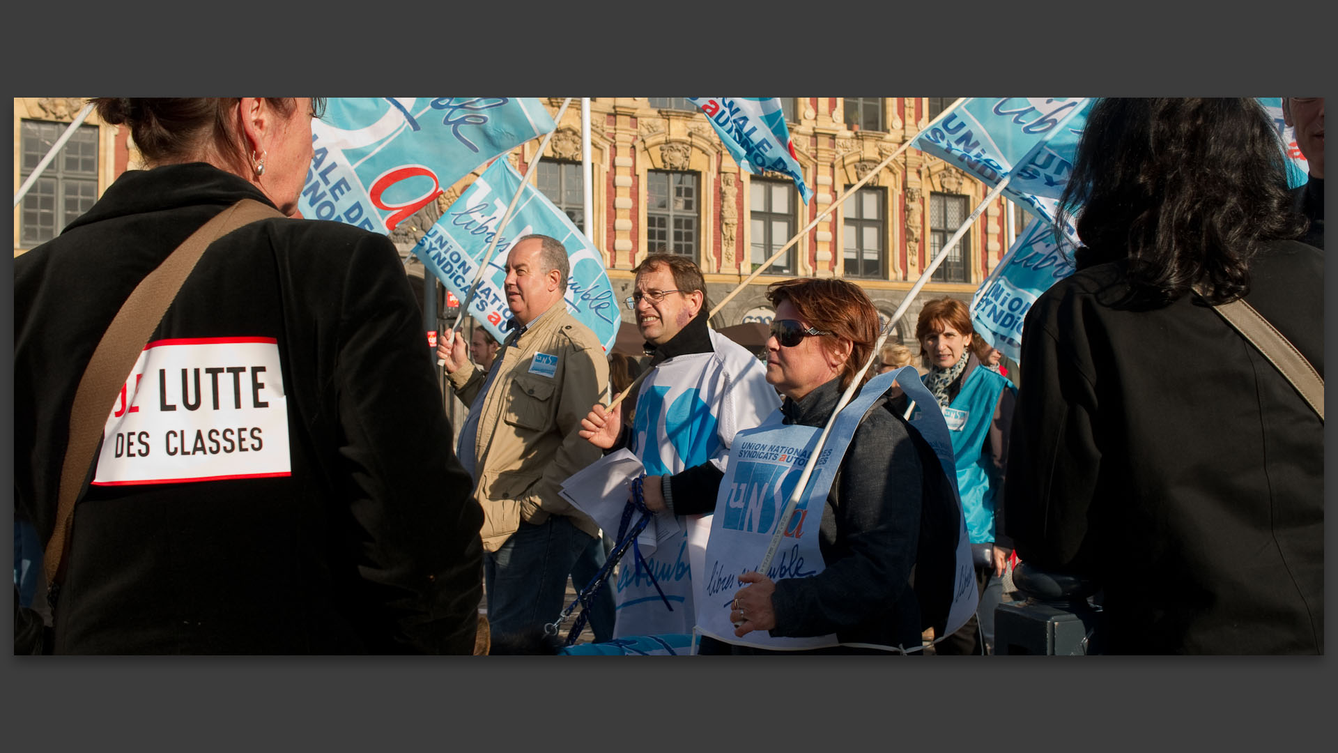 Femme portant l'écriteau "Je lutte des classes" dans la manifestation contre la réforme des retraites.